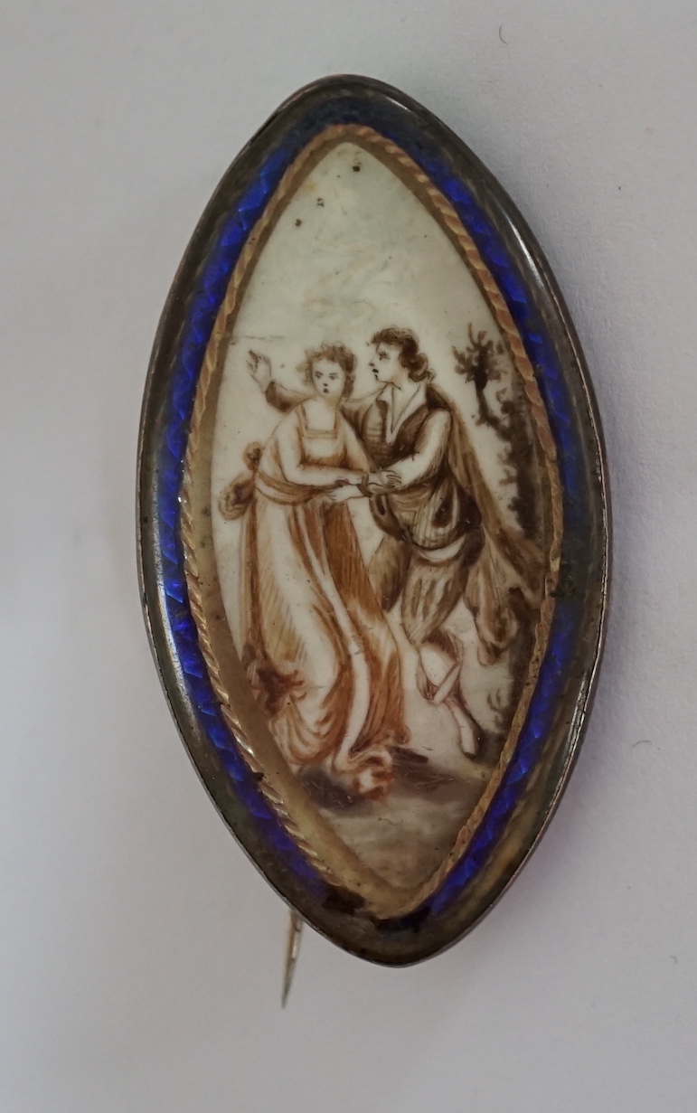 A Regency yellow metal and blue enamel mounted navette shaped pendant brooch, with inset ivory panel decorated with a lady and gentleman, 43mm. CITES Submission reference GAF52XTV